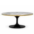 Coffee Table Parme Round Oval. A round dining table with a textured gray and white marble top, a polished gold rim, and a glossy black tulip base, shown on a solid white background.
