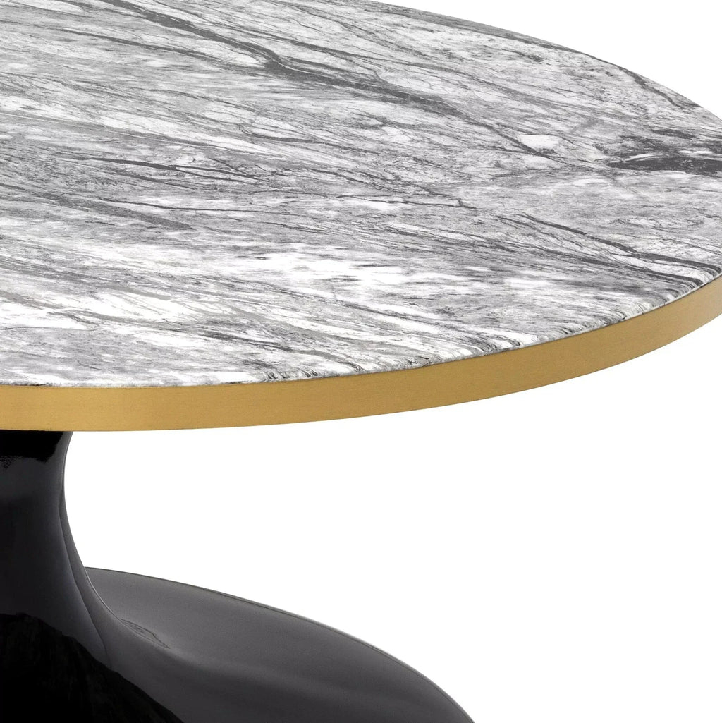 Close-up of a round dining table with a gray and white marble-patterned top, a brushed gold metal rim, and a glossy black pedestal base on a white background.